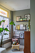 Reading chair in the living room with plants and gallery wall