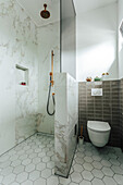 Modern bathroom with marble shower and hexagonal floor tiles