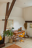 Work area with wooden desk and yellow chair