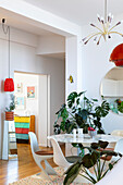 Dining room with white marble table, plants and retro-accents