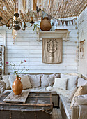 Covered terrace with rattan sofa and vintage decorations