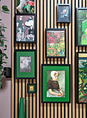 Framed artwork on a wooden slatted wall