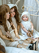 Old porcelain dolls in vintage clothes