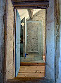 Rustic hallway with view into shower
