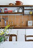 Open shelves above kitchen counters in country-style kitchen