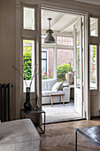 Bright living room with herringbone parquet flooring and patio doors