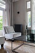 Light grey lounge chair and metal table in the modern living room