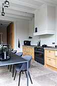 Kitchen with wooden cabinets and black furnishings in a modern home