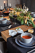 Festive dining table with fir branches and fairy lights