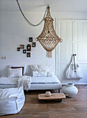 Bright living room with rustic macramé ceiling lamp