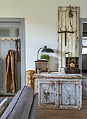 Rustic sideboard with lamp, plant and vintage decoration in the hallway