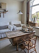 Country-style living room with rustic wooden table and white sofa