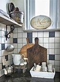 Country kitchen with wooden chopping boards, vintage decor and tiled backsplash