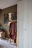 Hallway with wardrobe, white built-in wardrobe and a mural with a street