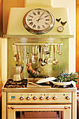 Vintage kitchen cooker with hanging shelf for cooking utensils and wall clock