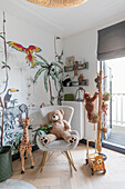 Children's room with wall painting of jungle animals and plush toys