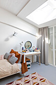 Bedroom with skylight, bed and dressing table