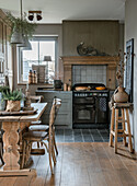 Country kitchen with wooden dining table and antique stove