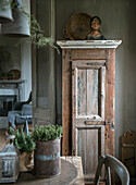 Old wooden cupboard with decorative figure in a rustic ambience