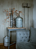 Vintage decoration on a small table next to a grey upholstered sofa