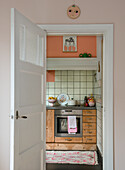 Small kitchen corner with wooden elements and retro decorations