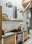 Modern kitchen with wooden cabinets, tiled backsplash and stainless steel extractor hood