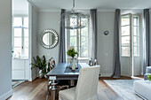 Modern dining room with wooden table and chrome legs