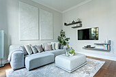 Modern living room with grey sofa landscape and wall-mounted TV