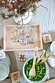 Set dining table with wooden tray, salad bowl and wooden cutlery