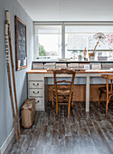 Desk with wooden chairs and chalkboard in the study