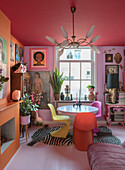 Colorful dining room with fireplace, vintage art and Panton chairs