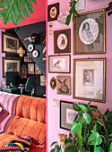 Gallery wall with animal illustrations in office living area with pink, pink and black accent walls