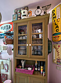 Vintage kitchen cabinet with crockery and spirits, surrounded by retro decorative elements