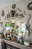 Vintage mirror decorated with sculptures and picture frames