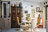 Dining area with oval table, retro chairs and antique cupboard