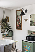 Vintage-style bathroom with flower-decorated mirrors and wall light