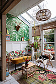 Conservatory with skylight, plant wallpaper and rattan armchair