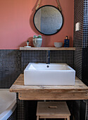 Modern vanity unit with wooden elements and mosaic tiles in black and white