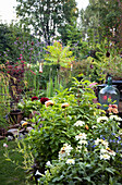 Lush summer garden and burning pole lanterns