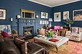 Living room with blue walls and eclectic furnishings
