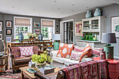Country-style living room with colourful accent cushions and vintage furniture