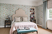 Bedroom with floral wallpaper and classic furniture design
