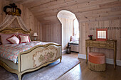 Louis XV-style bedroom with gilded bed crown and Canadian pine wall panelling