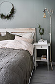 Bedroom with rustic wooden bed and plant decoration