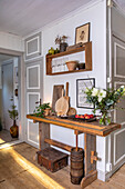 Rustic sideboard with decorative elements and flower vase in the hallway