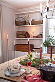 Dining table set with candles and Christmas decorations