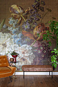 Floral pattern wallpaper in the living room with retro-look armchair and bench