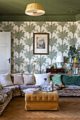 Living room with palm tree wallpaper, zebra print sofa and parquet flooring