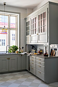 Light grey country kitchen with white tiled backsplash