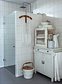 Vintage bathroom with open shower and white dresser